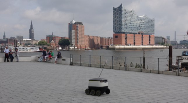 Pizza-Liefer-Roboter wird ab Sommer 2017 erstmals in Hamburg Kunden beliefern. Der Roboter passt sich laut Meldungen der Hersteller an die Geschwindigkeit dem Fußgängeraufkommen auf dem Bürgersteig an. Gegenstände und Hindernisse kann der Roboter mithilfe der On-Board-Sensoren ausweichen. (Foto: Starship Technologies, Pressefoto)