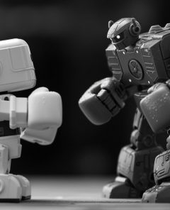 fivedust_a_black_and_white_image_of_a_tiny_toy_robot_facing_a__e5f0c891-1717-4da0-85be-76a9ad36088a